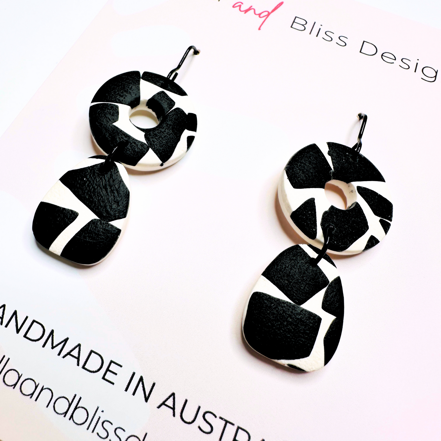 Black and white patterned earrings on a white background with 'Bliss Design' branding.