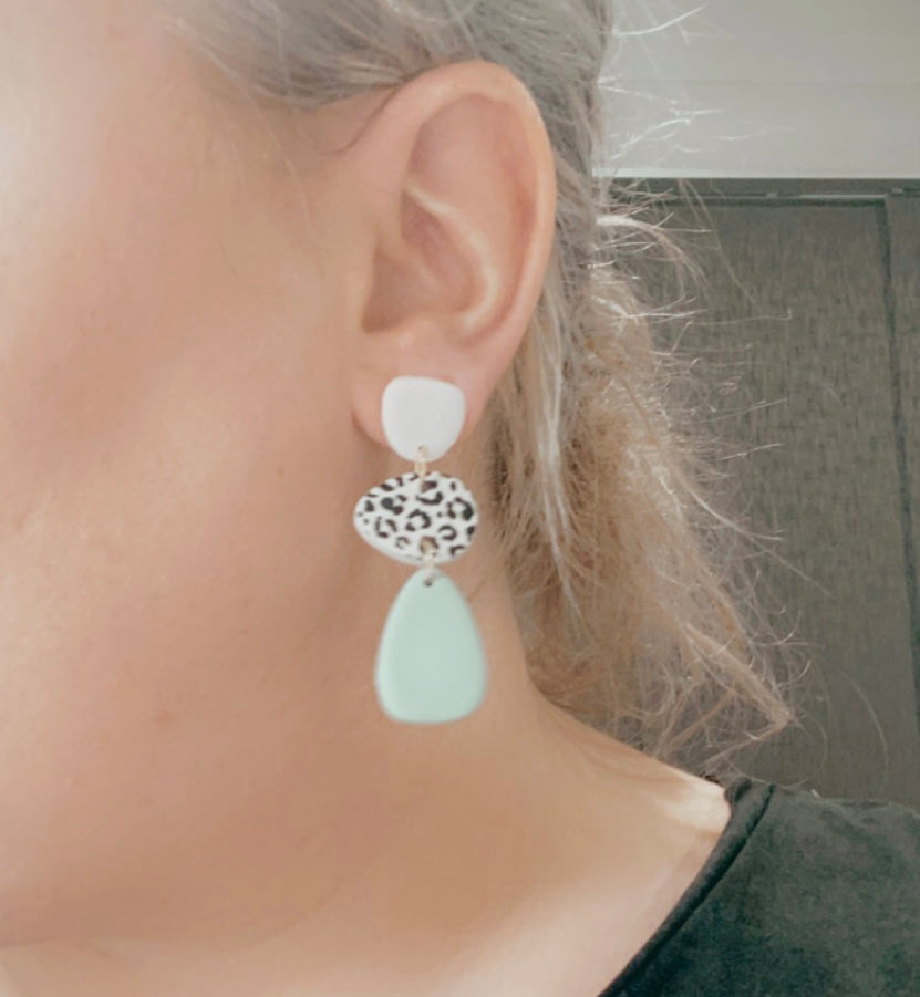 Blake leopard print earring size guide on a person.