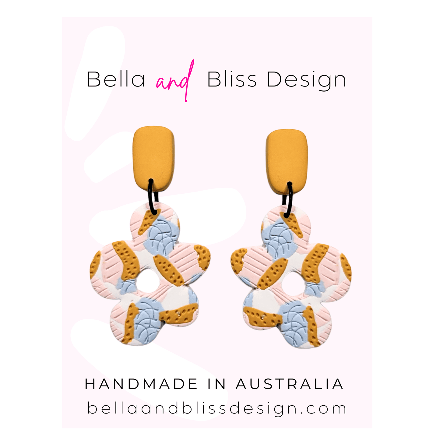 Pair of colorful earrings with 'Bella and Bliss Design' branding on a light pink background.