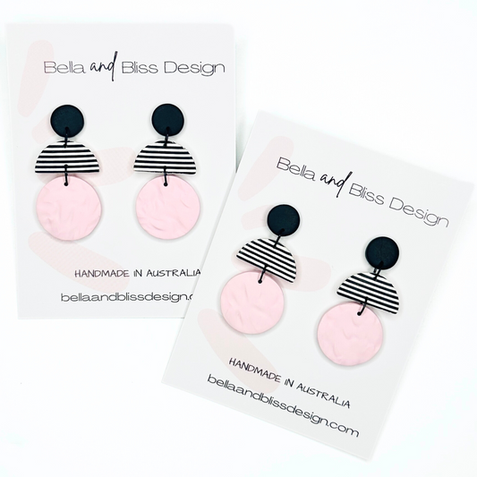 Earrings with pink and black design on a white background, featuring 'Bella and Bliss Design'.