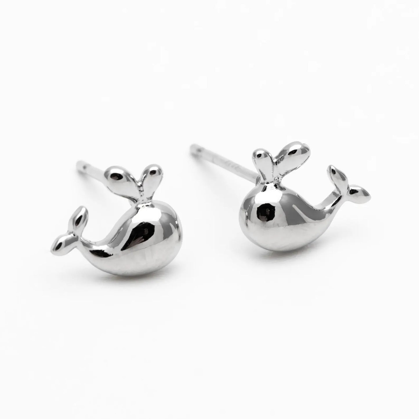Silver whale-shaped earrings on a white background