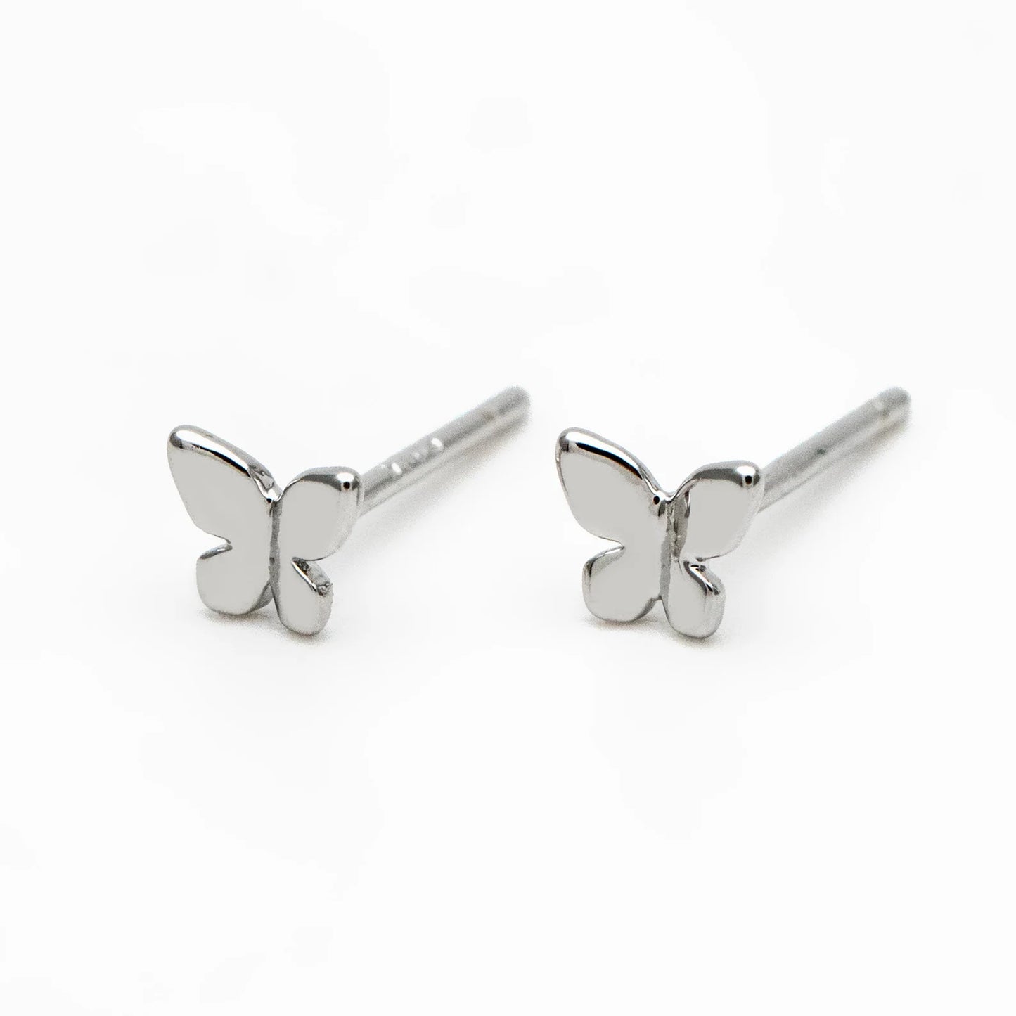 Butterfly-shaped silver earrings on a white background