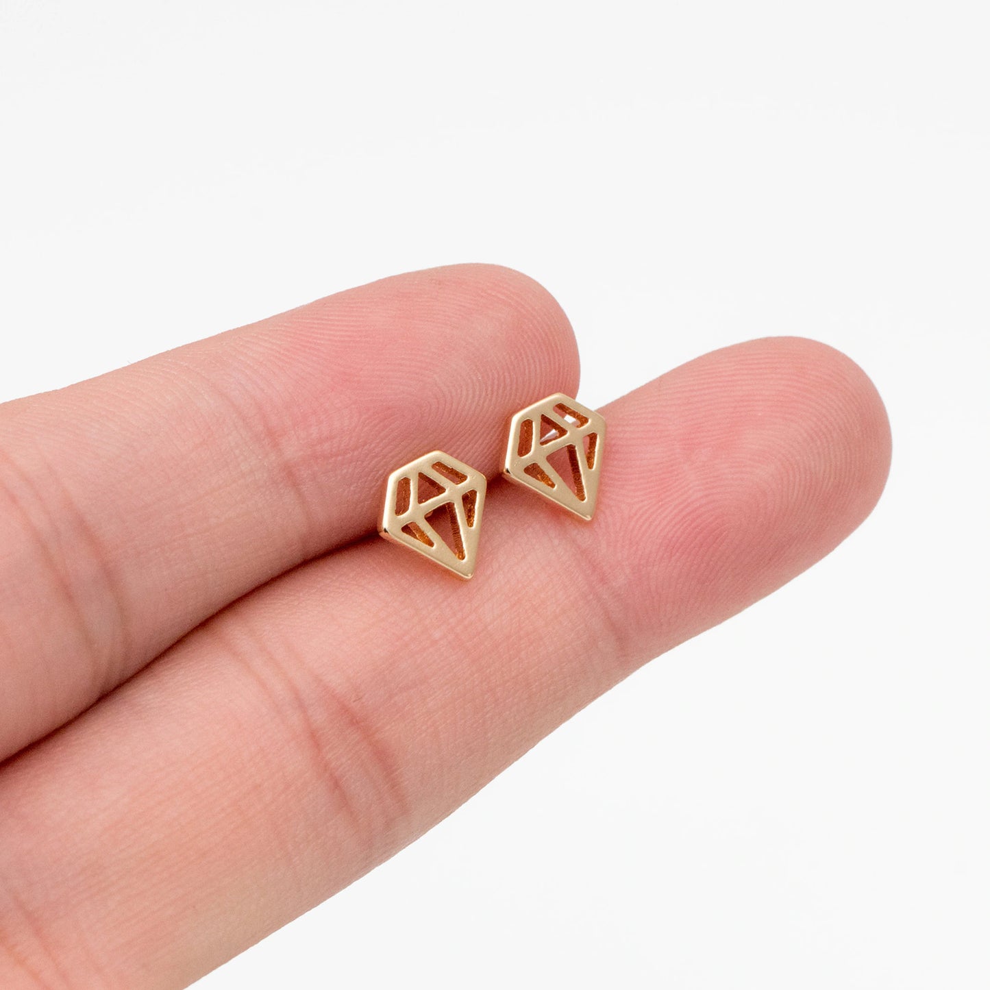 A pair of 18K gold plated mini stud earrings displayed on a branded card with 'Bella and Bliss Design' written on it.