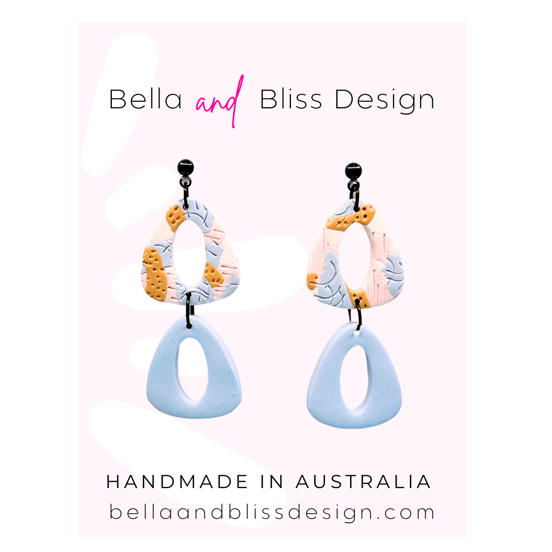 Colourful earrings with 'Bella and Bliss Design' branding on a light pink background.