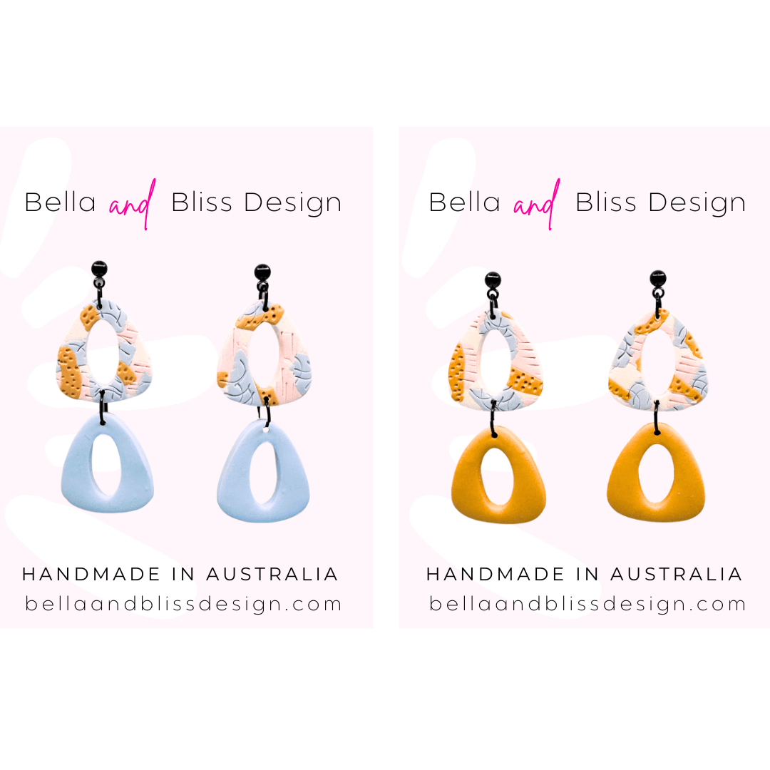 Pair of colorful earrings with 'Bella and Bliss Design' branding on a white background.
