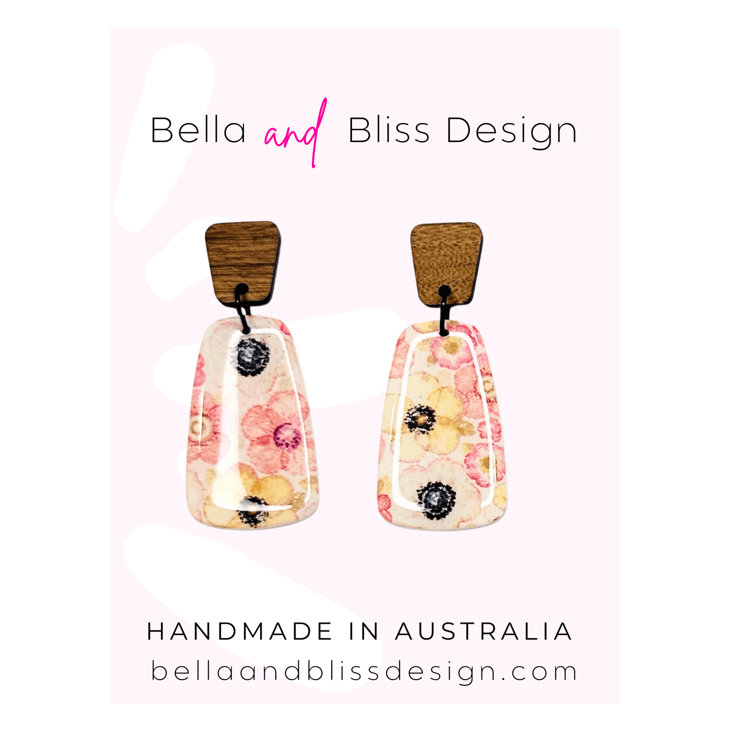 Floral earrings with wooden tops on a light pink background, branded as Bella and Bliss Design.