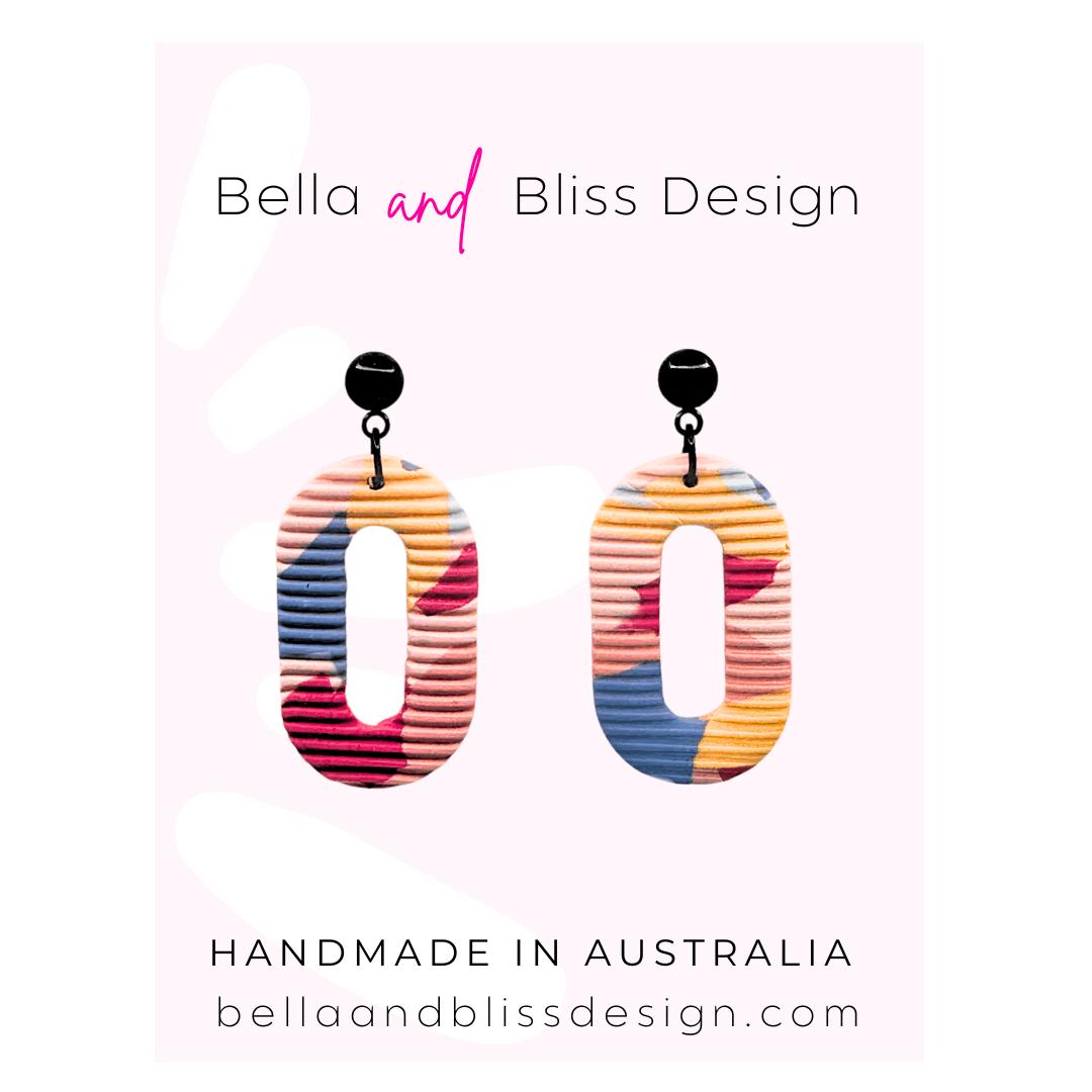 Colorful earrings on a pink background with 'Bella and Bliss Design' branding.