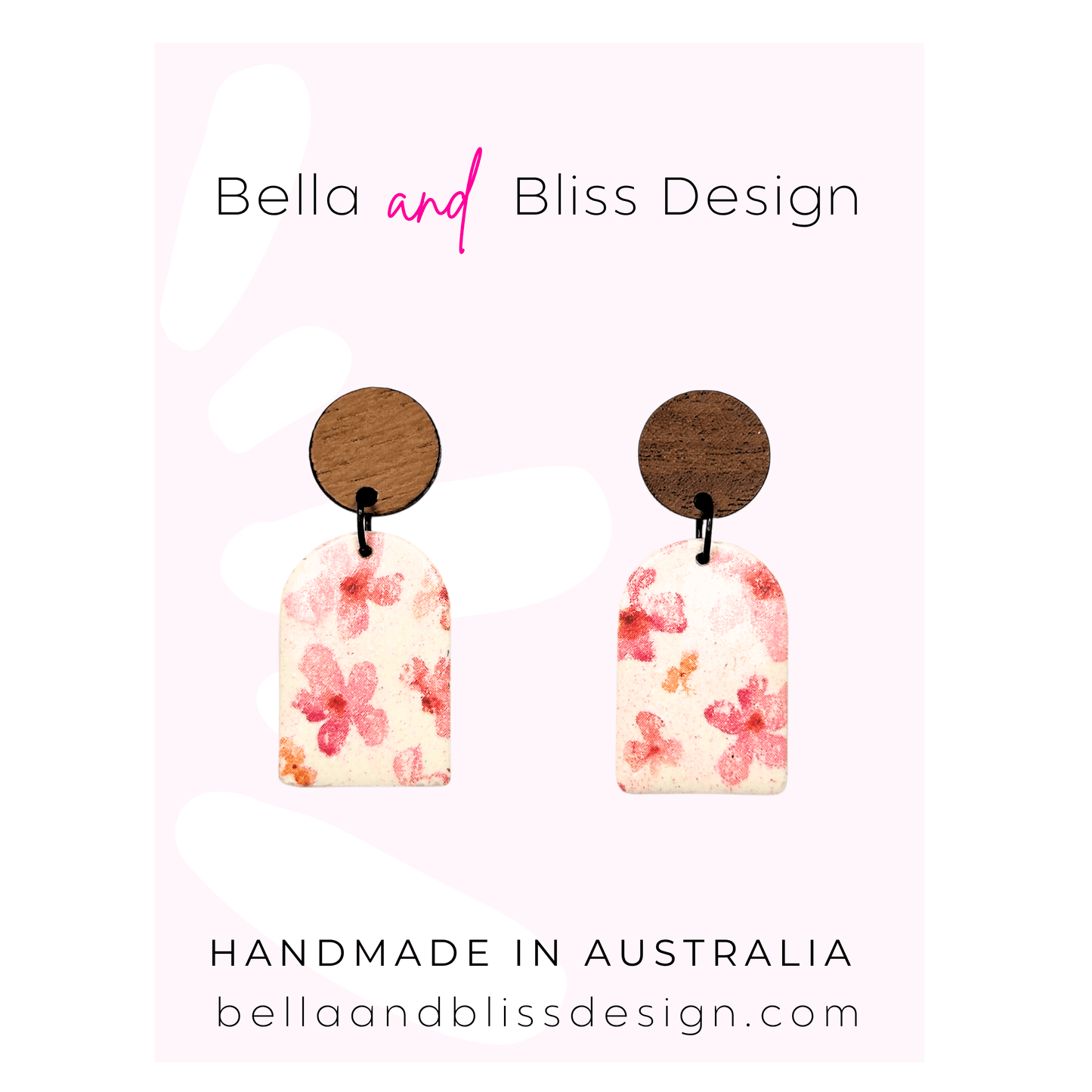 Pair of floral earrings with wooden backing on a pink background, branded 'Bella and Bliss Design'.