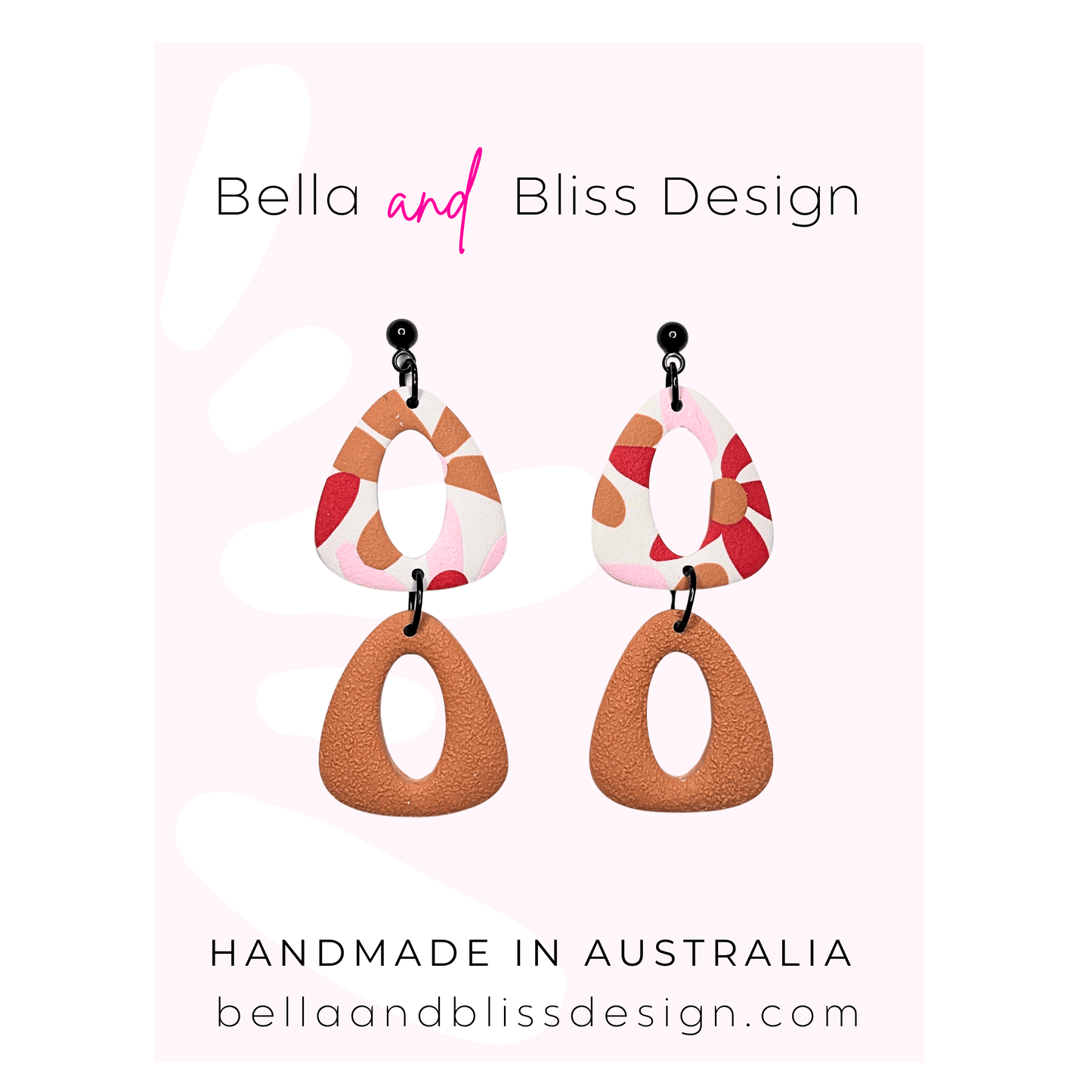 Pair of earrings with a colorful design on a pink background, featuring the brand 'Bella and Bliss Design'.