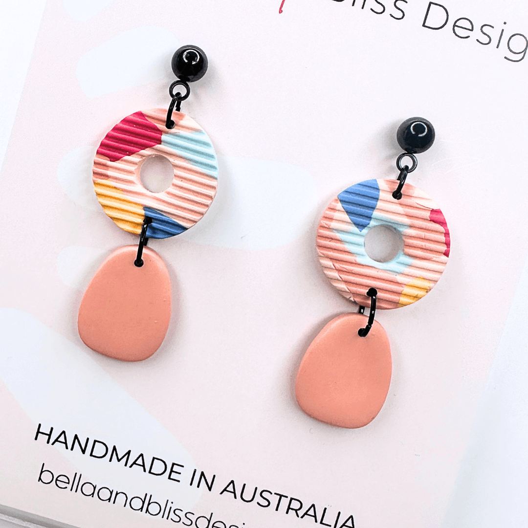 Colourful earrings with 'Bella and Bliss Design' branding on a white background.