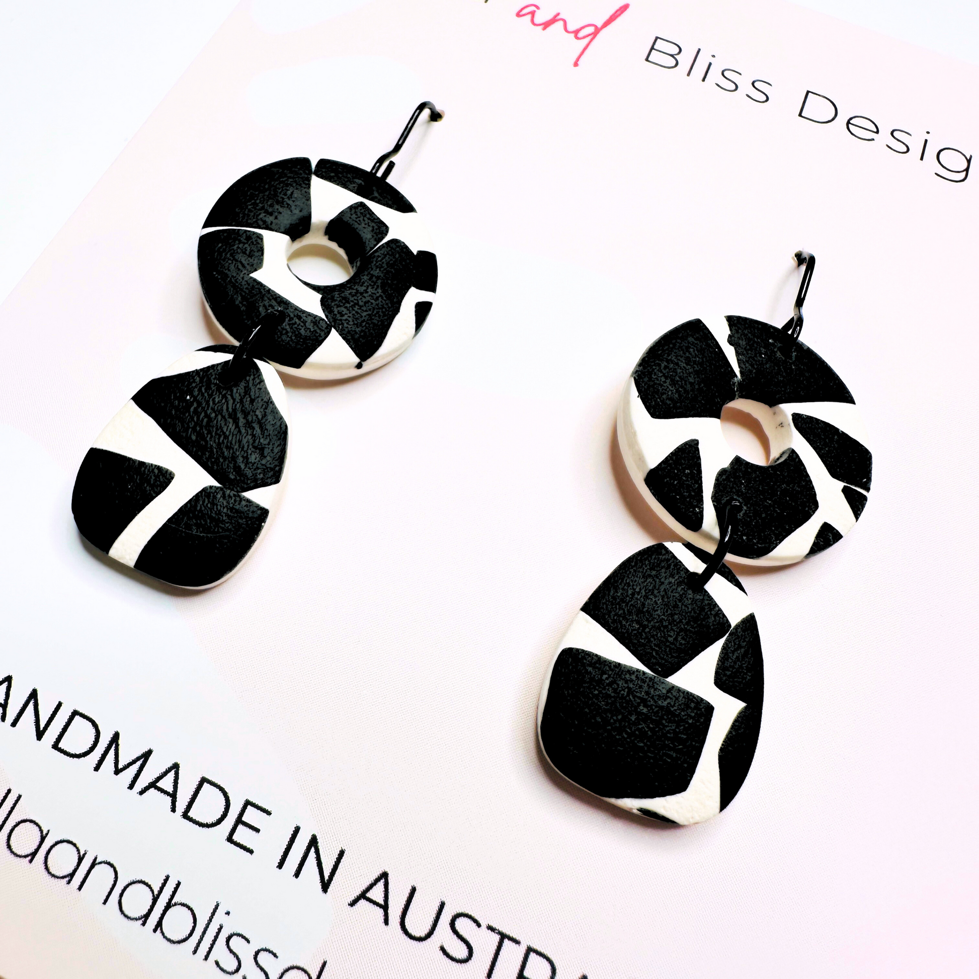 Black and white patterned earrings on a white background with 'Bliss Design' branding.