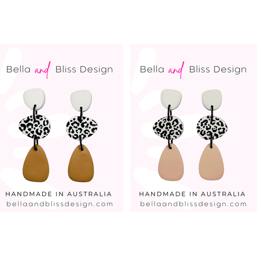Pair of earrings with leopard print details on a white background, branded as Bella and Bliss Design.