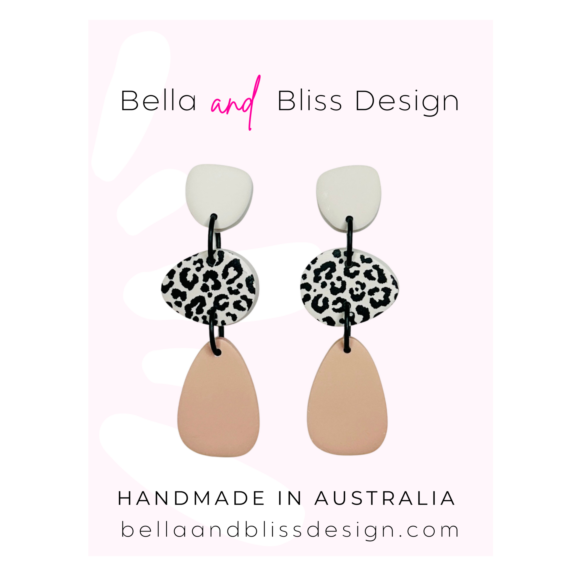Pair of earrings with leopard print and beige design on a white background with Bella and Bliss Design branding.