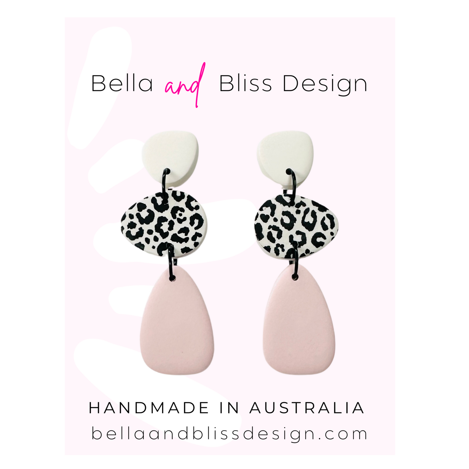 Pair of earrings with leopard print and pink teardrop design on a light pink background, branded as Bella and Bliss Design.