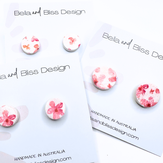 Floral earrings on a Bella and Bliss Design card with branding.