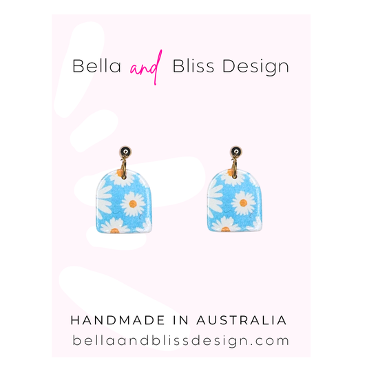 Colorful earring designs on white cards with 'Bella and Bliss Design' branding.