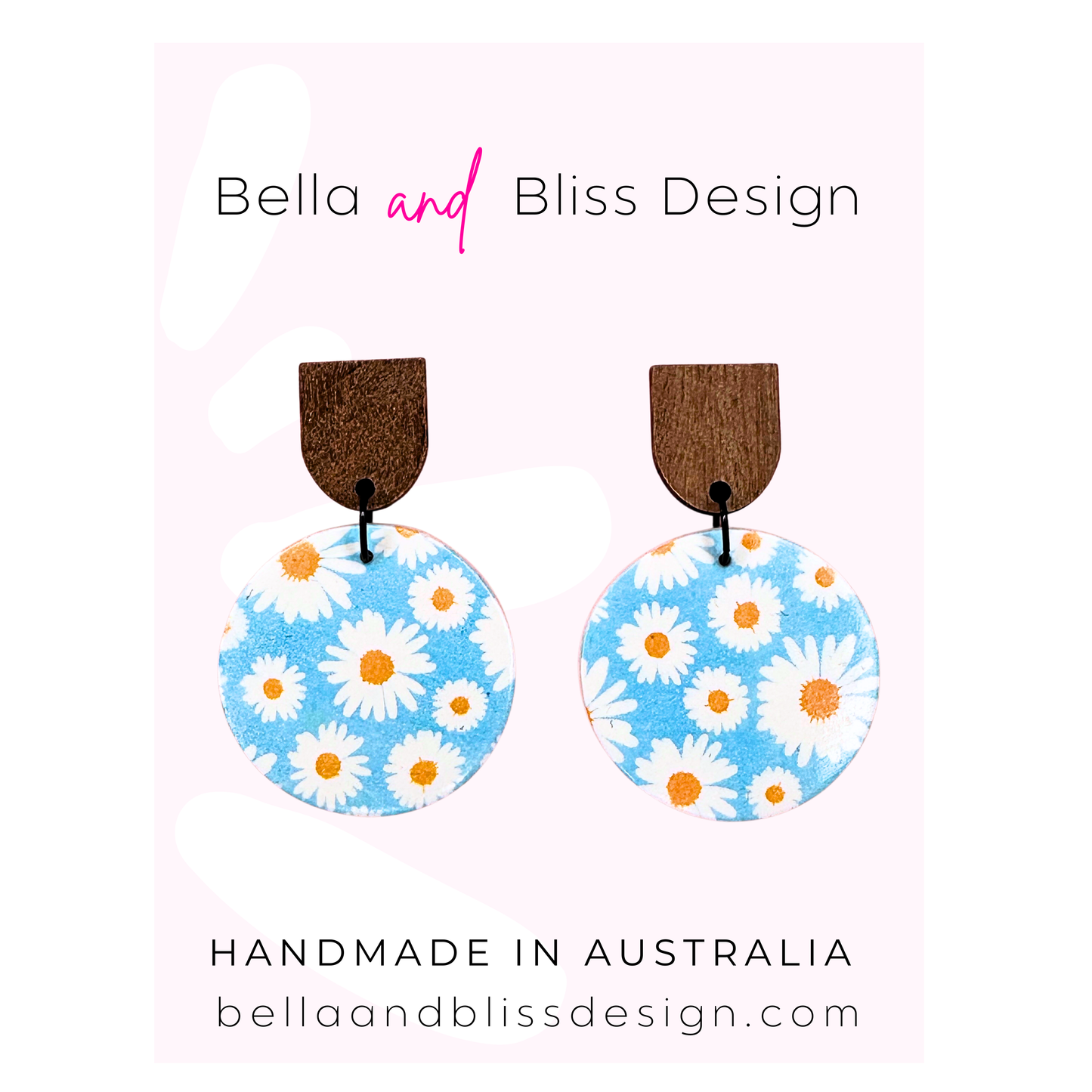 Earrings with floral design on a card with Bella and Bliss Design branding.