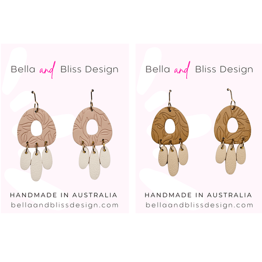 Pair of earrings with wooden and beige elements, branded 'Bella and Bliss Design'.