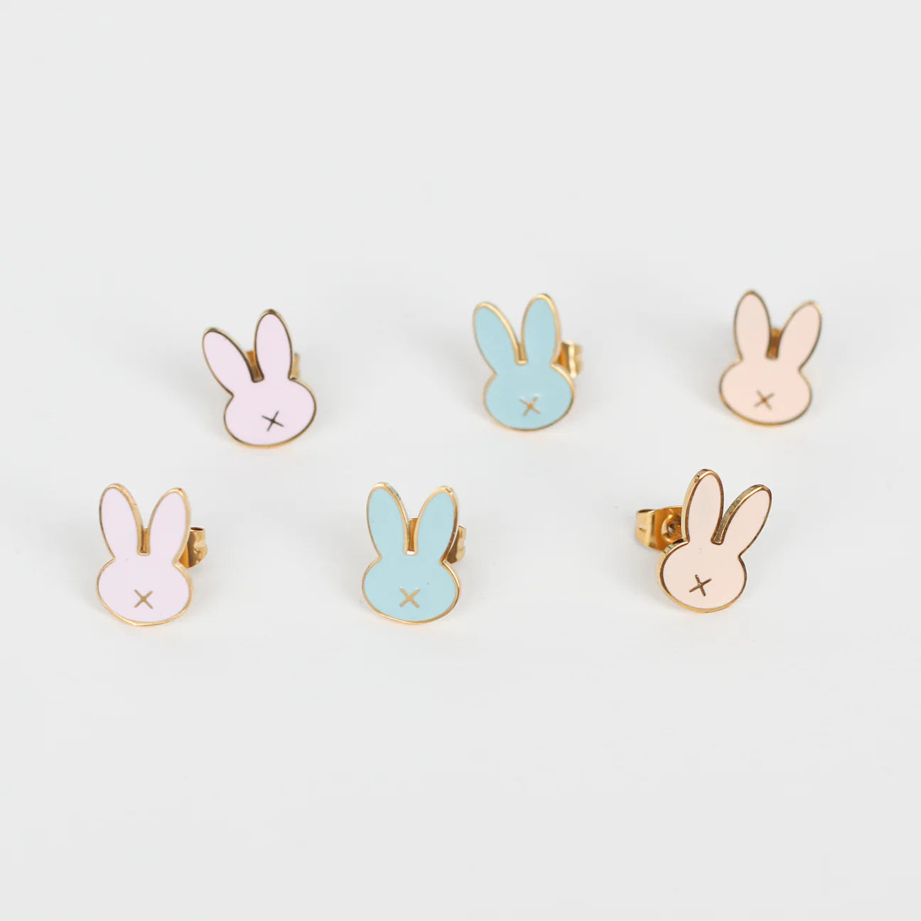 Set of bunny-shaped earrings on a light gray background