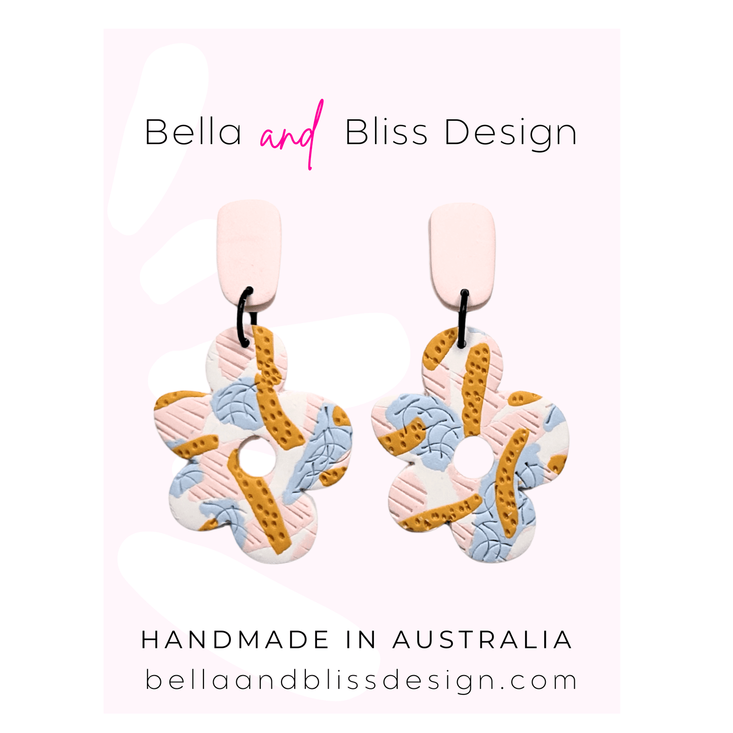 Colorful earrings with 'Bella and Bliss Design' branding on a pink background