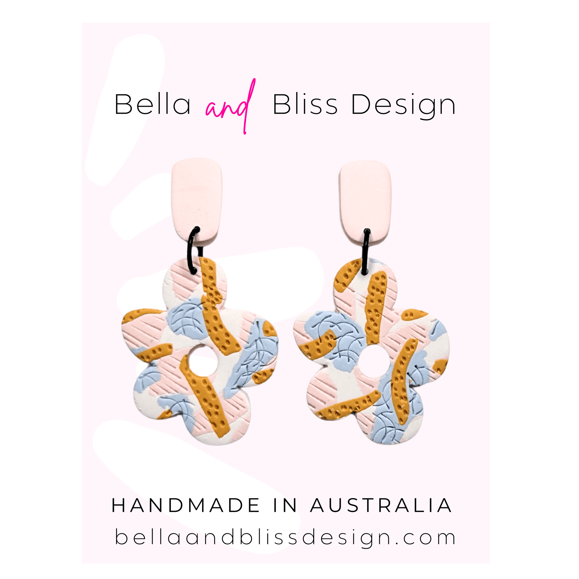 Colorful earrings with 'Bella and Bliss Design' branding on a pink background