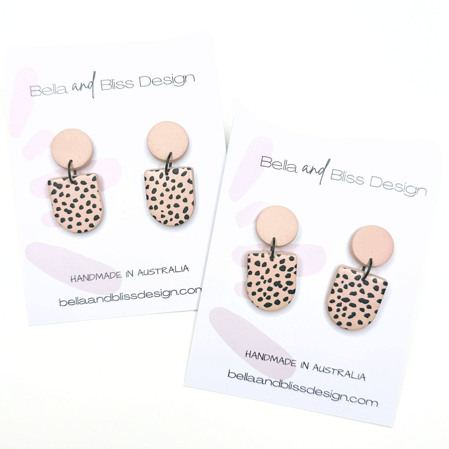 Pair of earrings with spotted design on a white background with 'Bella and Bliss Design' branding.