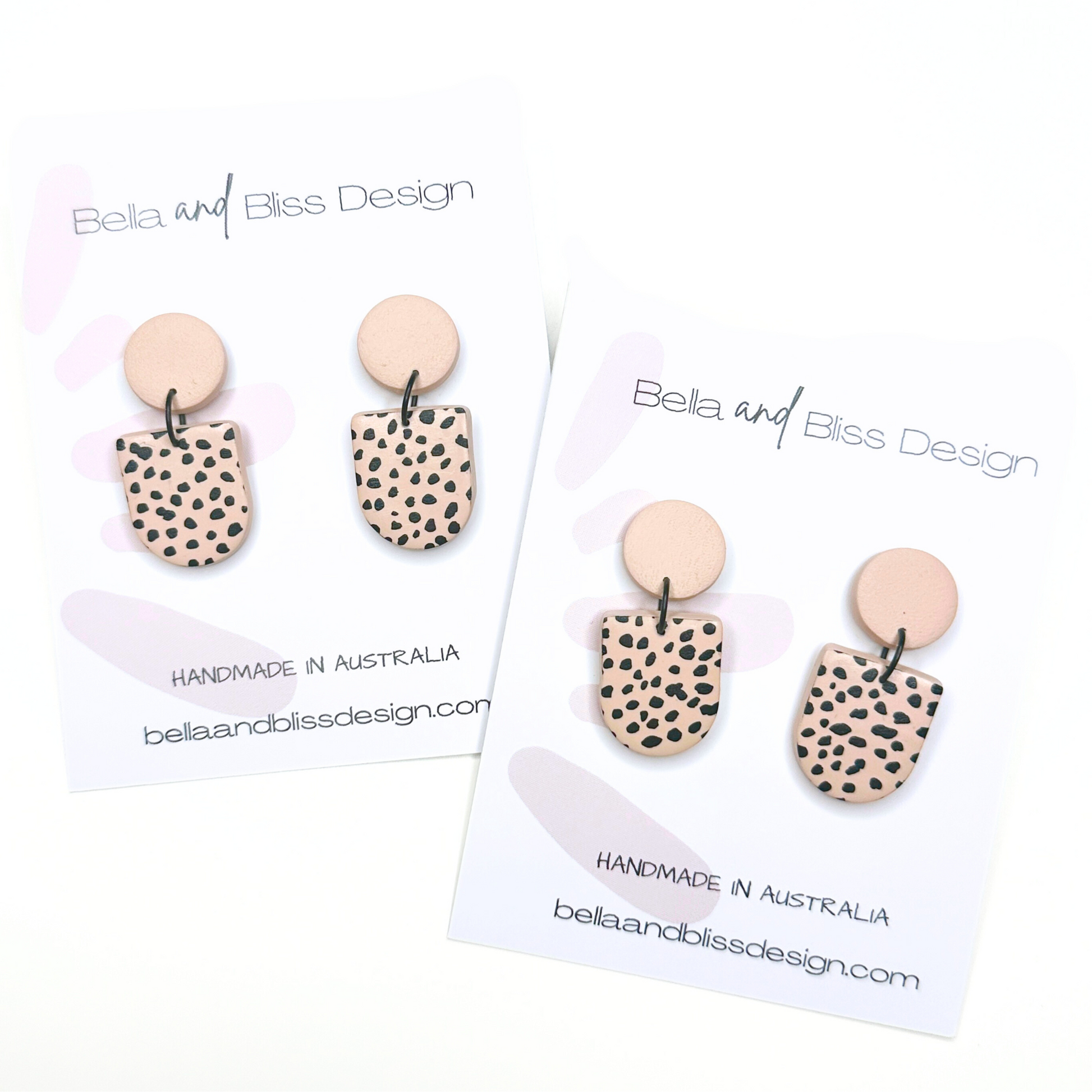 Pair of earrings with spotted design on a white background with 'Bella and Bliss Design' branding.
