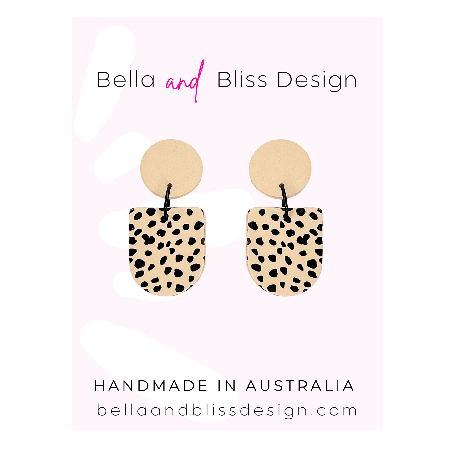 Pair of earrings with spotted design on a pink background with Bella and Bliss Design branding.