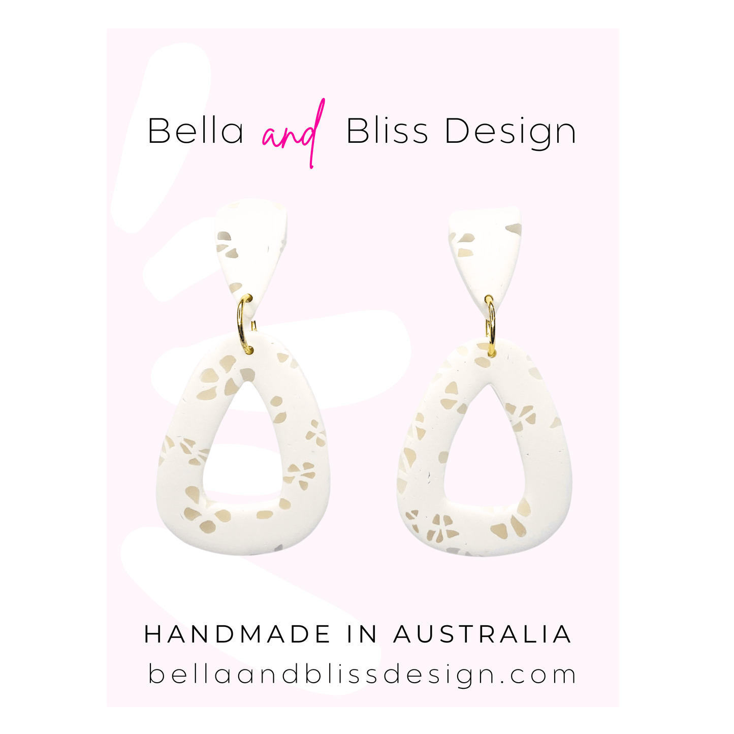 White teardrop earrings with gold accents on a pink background, featuring Bella and Bliss Design branding.