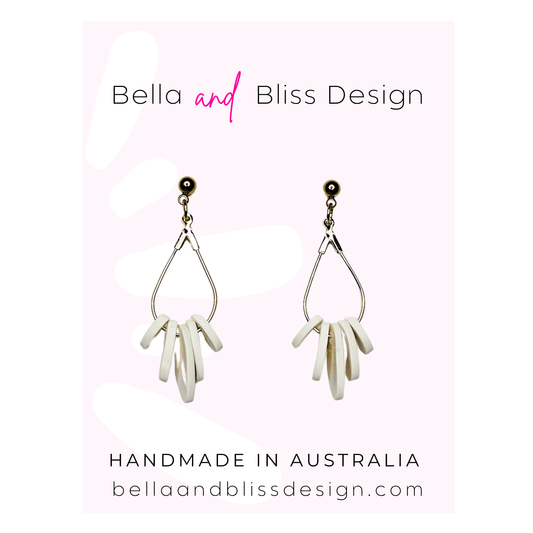 Pair of earrings with 'Bella and Bliss Design' branding on a white background.