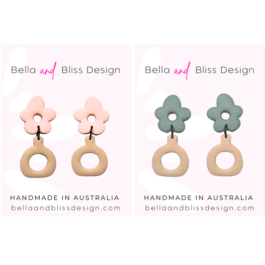 Flower-shaped earrings with beige loops on a light pink background, featuring Bella and Bliss Design branding.