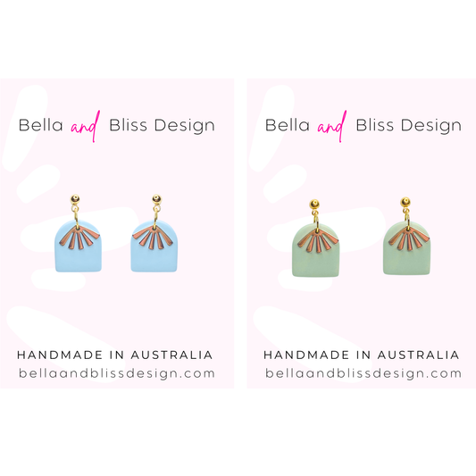 Pair of earrings with geometric design on a white background, branded 'Bella and Bliss Design'.