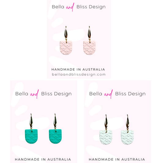 Earrings with wavy patterns on a white background with 'Bella and Bliss Design' branding.