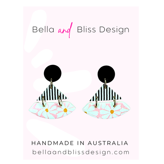 Earrings with colorful design on a light pink background, featuring 'Bella and Bliss Design' branding.