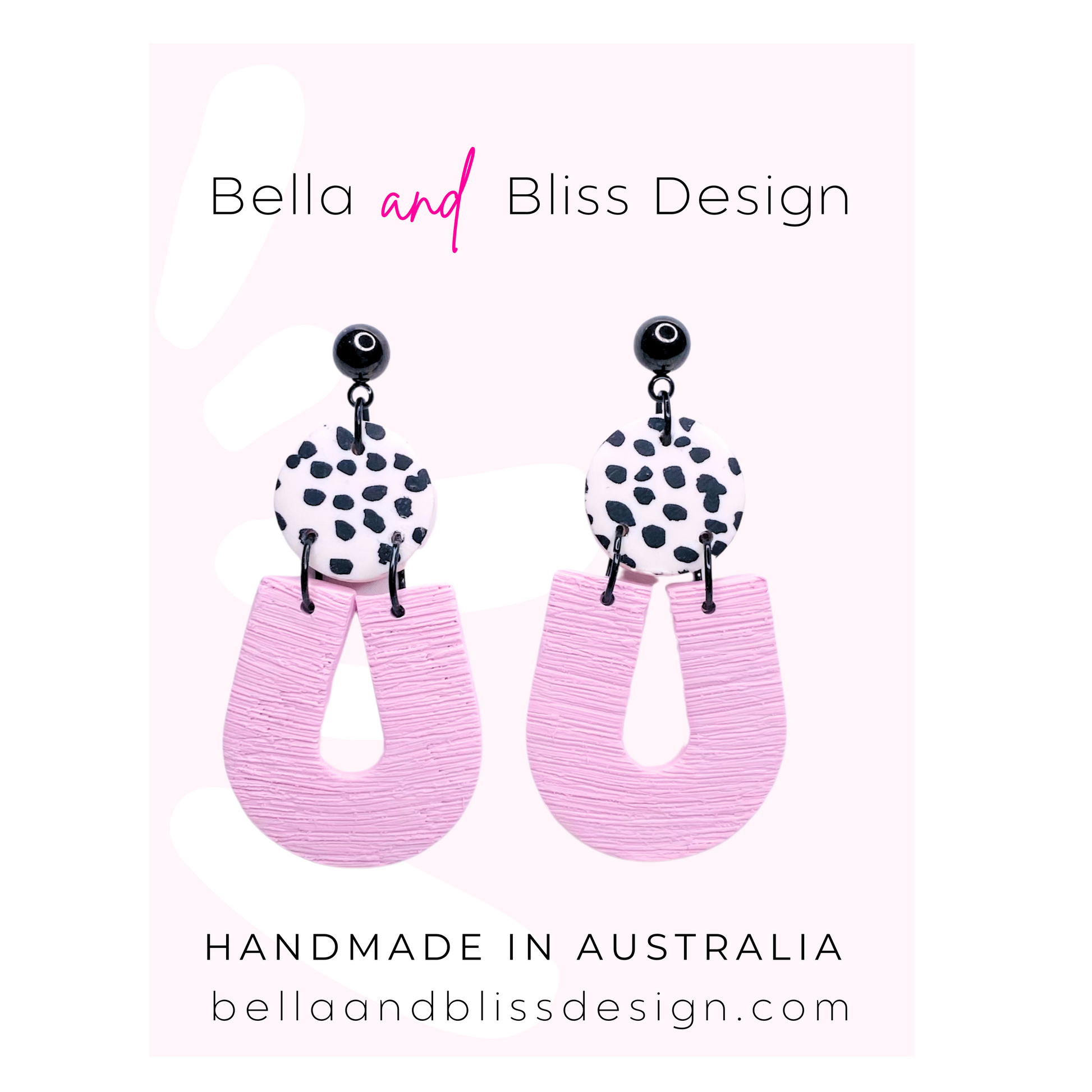 Pink earrings with black and white patterned tops on a light pink background, featuring Bella and Bliss Design branding.