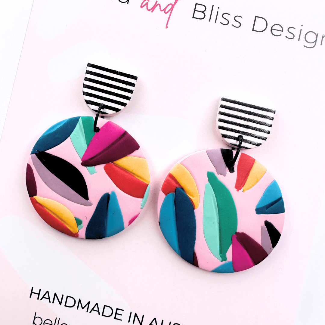 Colourful earrings on a card with 'Bella and Bliss Design' branding.