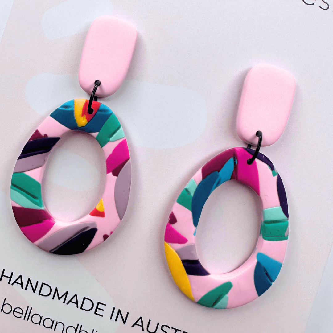 Colourful earrings on a card with 'Bella and Bliss Design' branding.