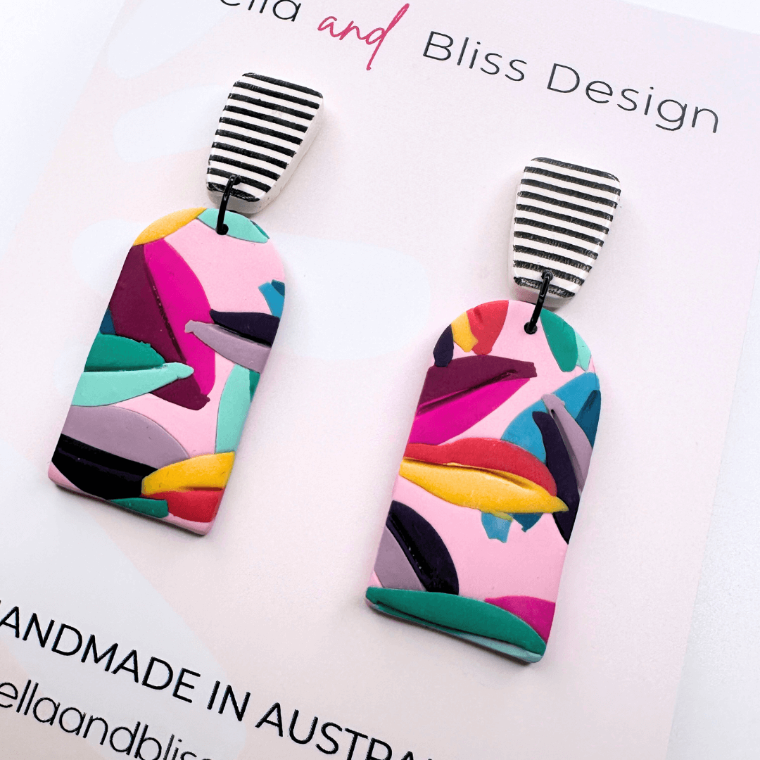 Colourful earrings on a card with 'Bella and Bliss Design' branding.
