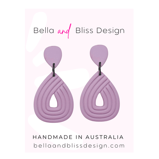 Purple earrings with 'Bella and Bliss Design' branding on a light purple background.