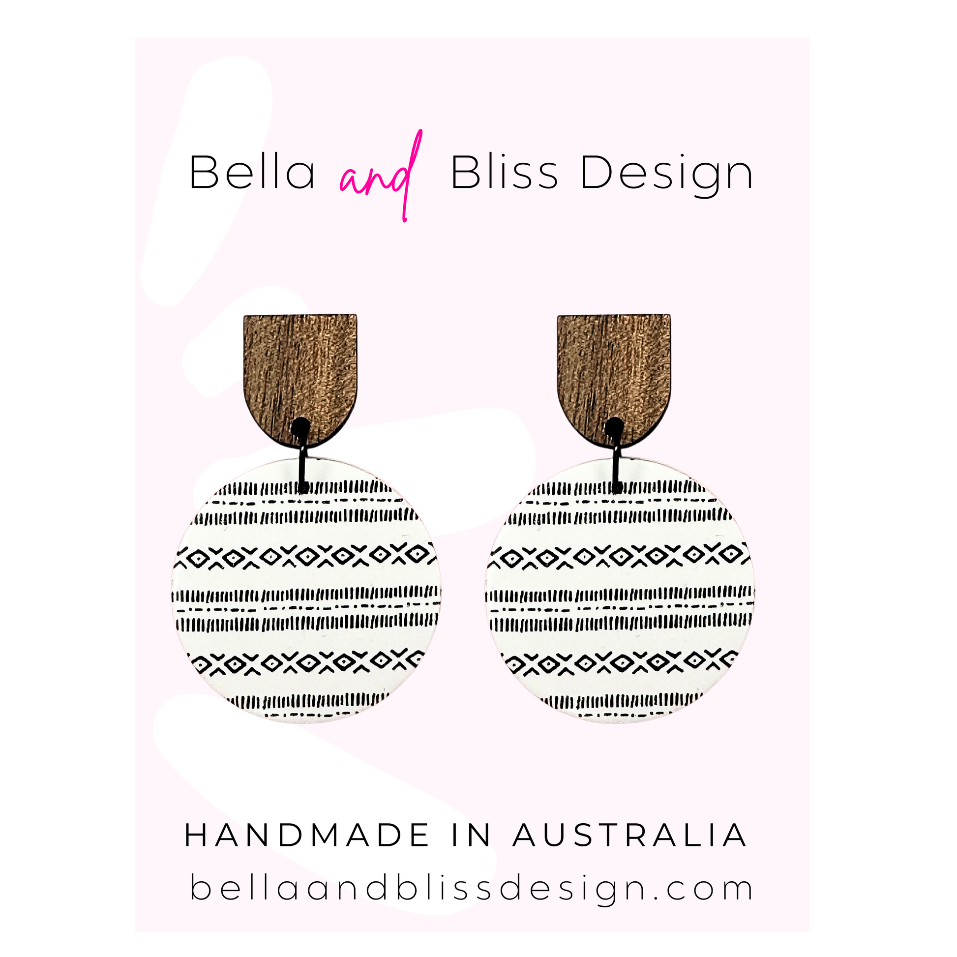 Wooden earrings with black patterns on a pink background, featuring 'Bella and Bliss Design'.