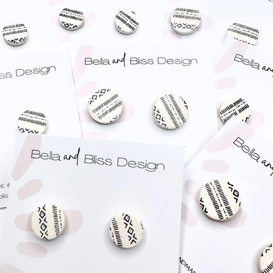 Bella and Bliss Design earrings on display with branded cards.