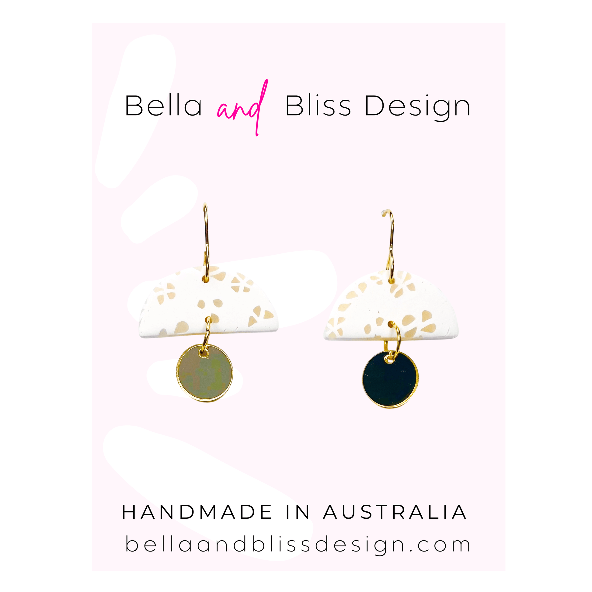 Pair of earrings with gold and black disc designs on a white card with Bella and Bliss Design branding.