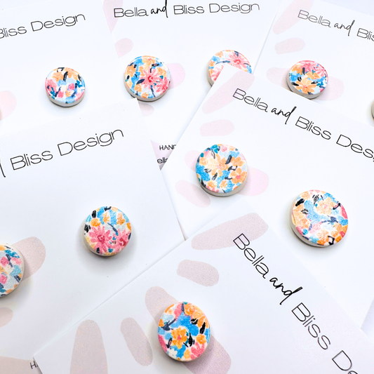 Floral earrings on a branded card with 'Bella and Bliss Design' branding.