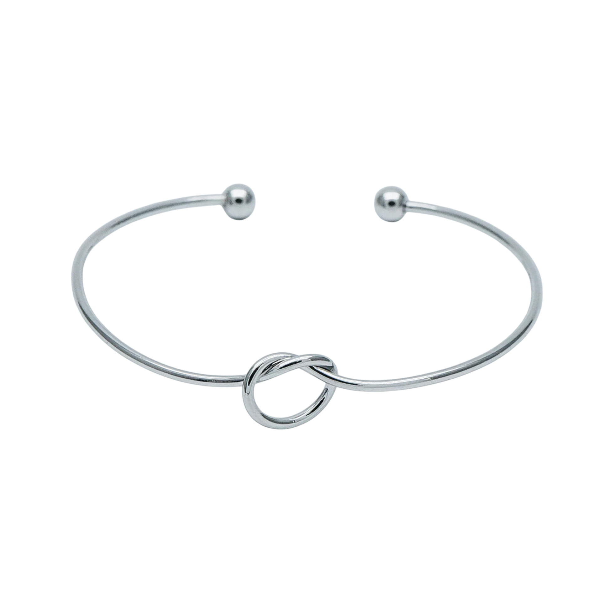 Silver bangle with a knot design on a white background