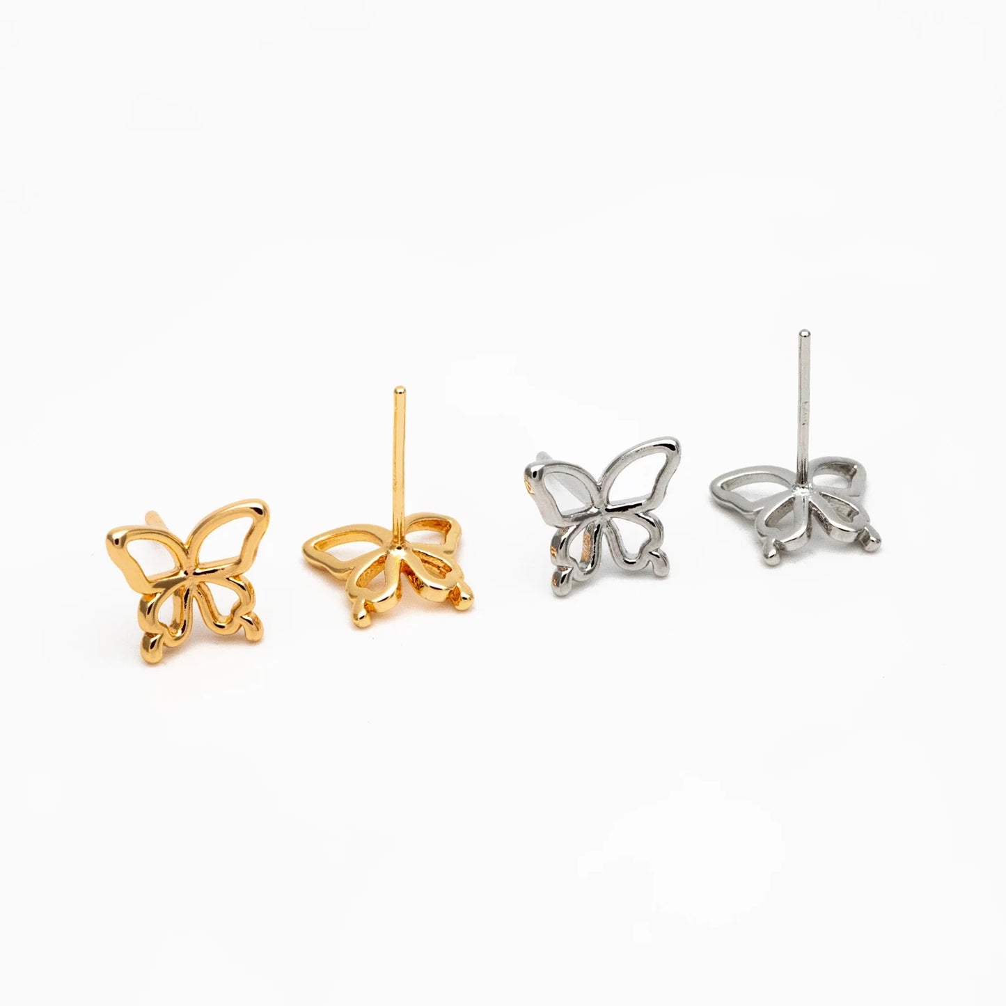 Butterfly-shaped earrings in gold and silver on a white background
