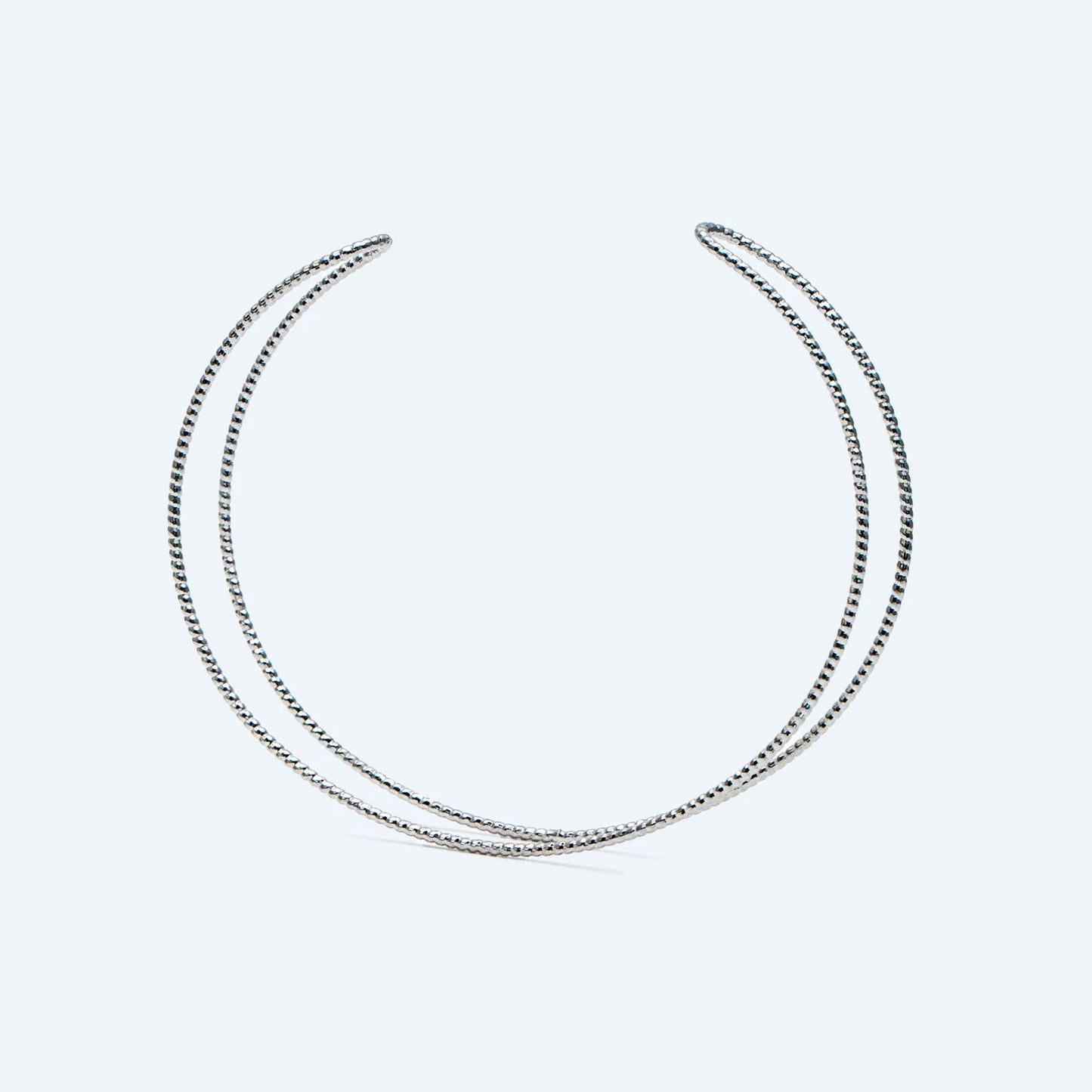 Two silver necklaces on a light gray background