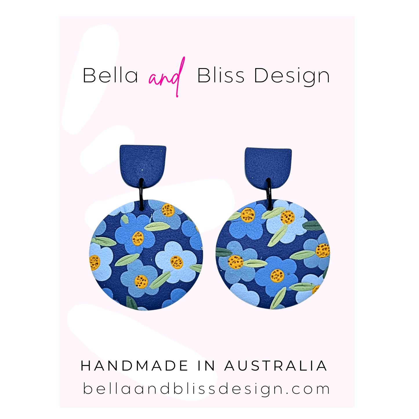 Blue floral earrings with 'Bella and Bliss Design' branding on a pink background
