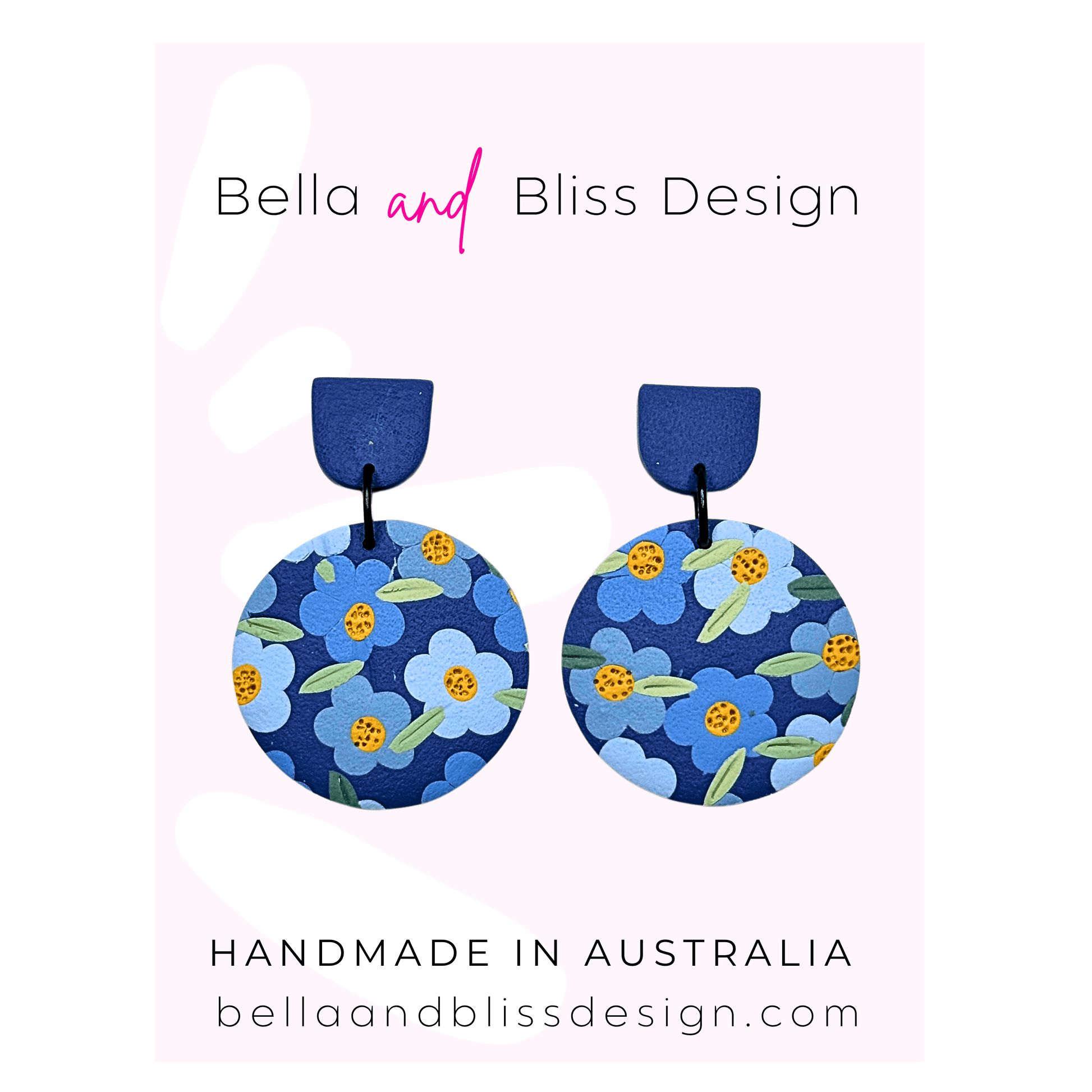 Blue floral earrings with 'Bella and Bliss Design' branding on a pink background