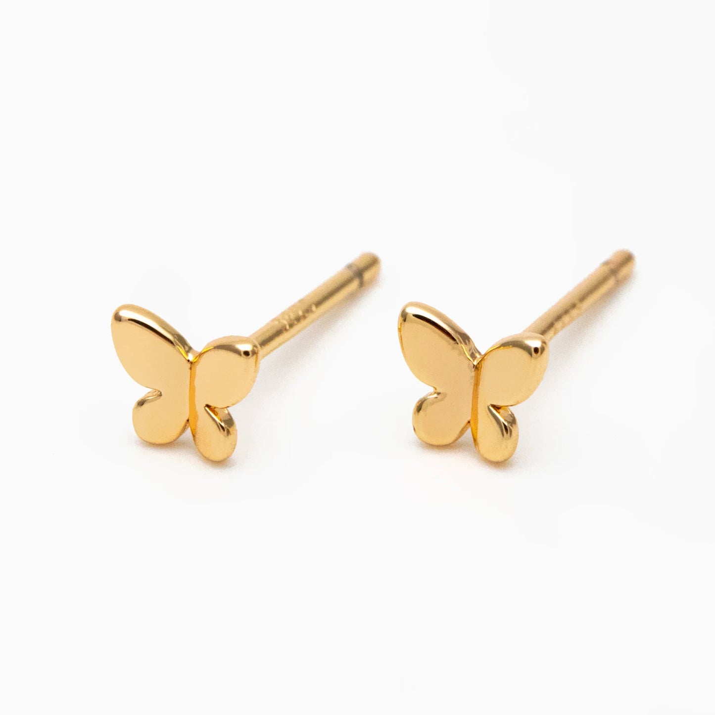Gold butterfly-shaped earrings on a white background
