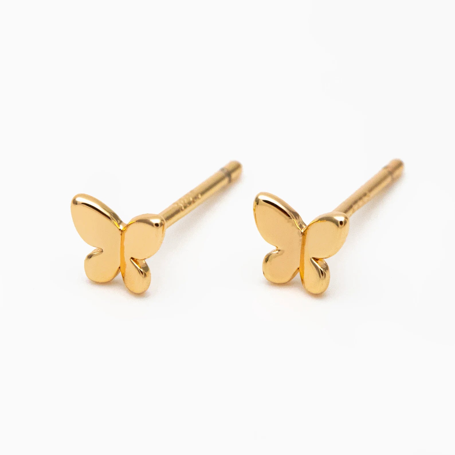 Gold butterfly-shaped earrings on a white background